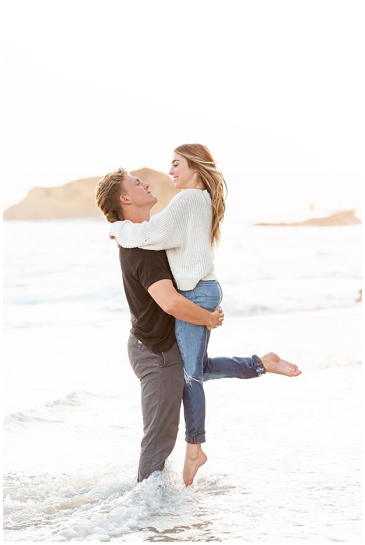 Guy lifting fiance in the air 