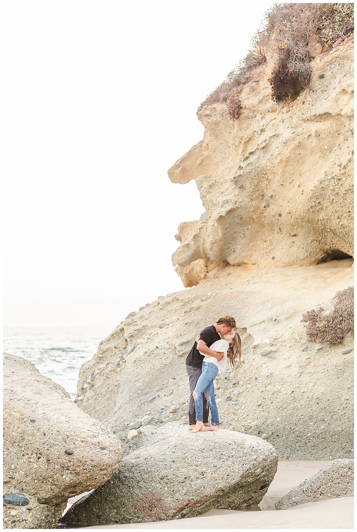 Couple kissing on rock