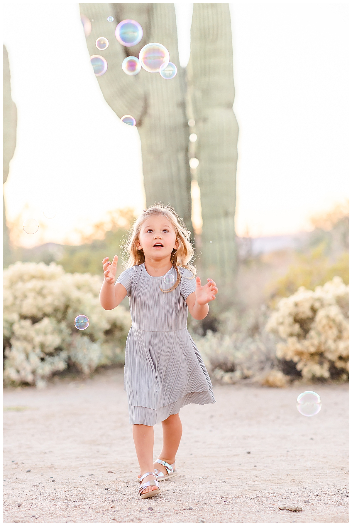 Girls dancing with bubbles in the desert in Scottsdale, AZ photographed by Christine Deaton Creative