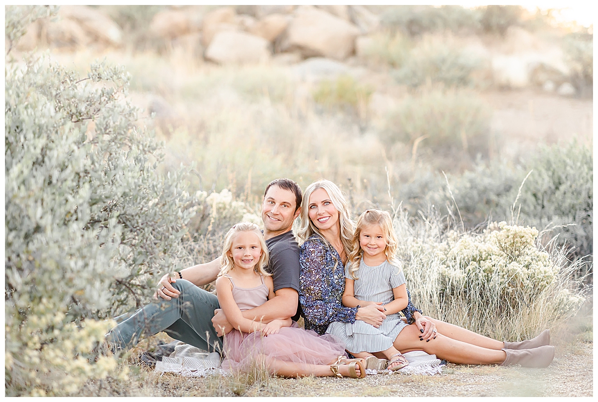Family smiling on picnic blanket in Scottsdale, AZ photographed by Christine Deaton Creative