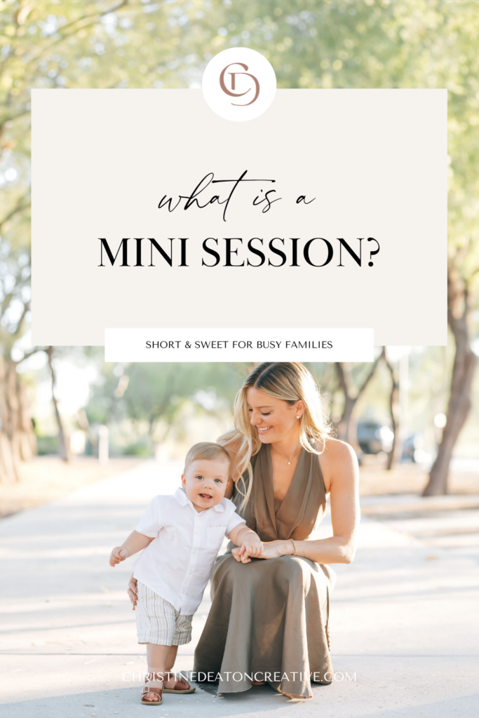 Full body vertical photo of mom and toddler boy surrounded by light Arizona earthy tones of trees and ground. Mom crouched down on sidewalk as son stands and uses her legs/arm for support. Right, blonde mom smiling at camera and wearing a satin, brown maxi halter dress. pearl stud earrings, necklace and diamond tennis bracelet arm around toddler son wearing a white button-up shirt, khaki shorts looking at the camera. Overlay of tan block with words reading, "What is a mini session? Short & Sweet for busy families"